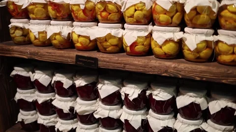 Homemade preserved vegetables stacked on rustic wooden shelves Stock Footage 327093573