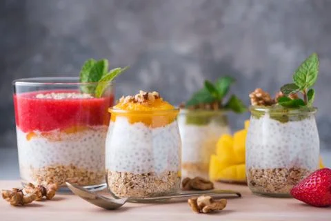 Homemade pudding of Chia seeds and almond milk with cereals and puree of kiwi Stock Photos
