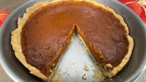 Homemade pumpkin pie missing a slice Stock Footage 212501340