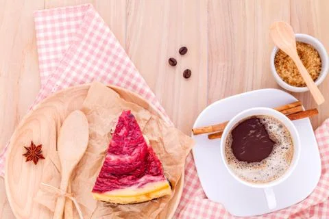 Homemade raspberry cake with cup of coffee on wooden background. Stock Photos