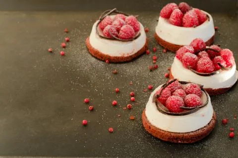 Homemade raspberry cakes on dark border background. Free space for your text Stock Photos