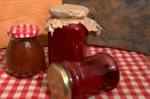 Homemade raspberry jam jars in modern kitchen Stock Photos