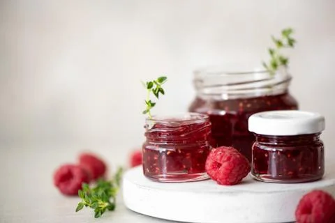 Homemade raspberry jam in small jars Stock Photos