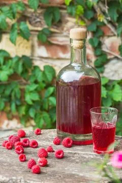 Homemade raspberry liqueur Stock Photos