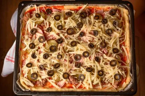 Homemade rectangular pizza requiring baking 스톡 사진