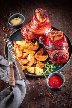 Homemade roasted pork knuckle as regional dish in Bavaria. Stock Photos