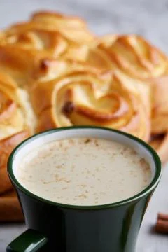 Homemade rose bread, cup of coffee, anise and cinnamon on white textured Stock Photos
