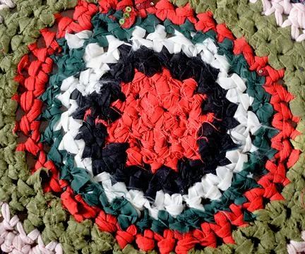 Homemade round rug in the patchwork technique. Stock Photos