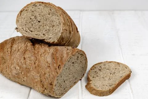 Homemade sliced bread on white rustic wooden table Stock Photos