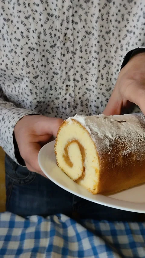 Homemade sponge cake roll with jam on a plate. Видео 334667313