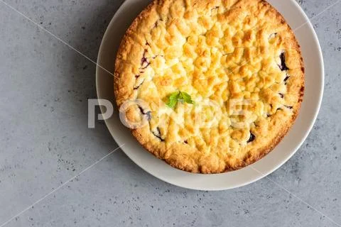Homemade tasty shortcrust pie with fruit or jam, crumble and mint. Stock Photos