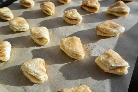Homemade triangular-shaped cottage cheese cookies with sugar and cinnamon. co Stock Photos