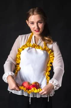 Homemaker with apples in apron Stock Photos