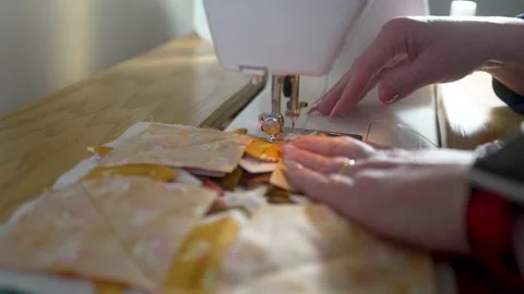 Homemaker sewing a homemade potholder on the machine - isolated close up Stock Footage 167628202