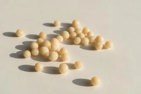 Homeopathic balls on the surface. Stock Photos