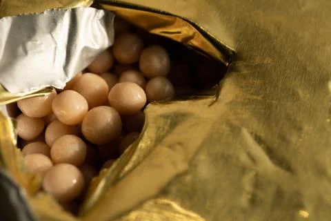 Homeopathic pellets in a container with an opened protective membrane. Stock Photos