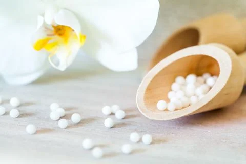 Homeopathic pills with orchid. Stock Photos