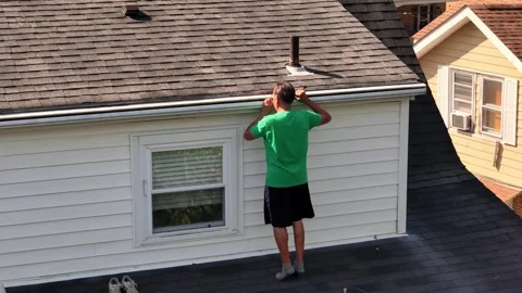 Homeowner Checks Rain Gutter for Clogs   Stock Footage 345600002
