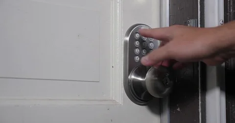 Homeowner Enters Passcode on Door for Entry Video stock 82442852