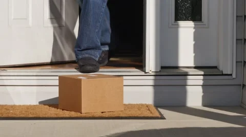 Homeowner Gets Package Delivery on Doorstep Stock Footage