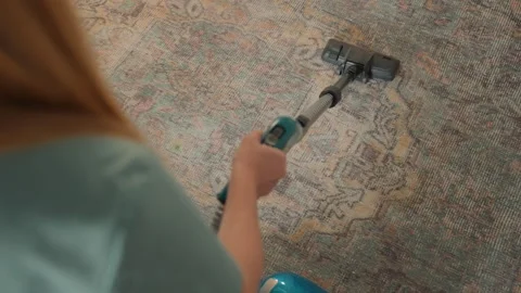 Homeowner refreshes textured carpet efficiently. Modern interior shown as Stock Footage 341973804