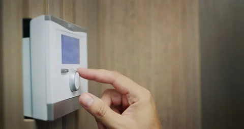 The homeowner regulates the temperature in the house Stock Footage 206337508