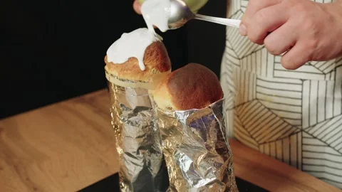 Homestyle bakery scene with baker decorating bread in warm kitchen Video stock 330537082