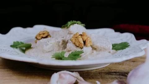 Homestyle culinary presentation: coating cooked duck with satsivi 스톡 사진