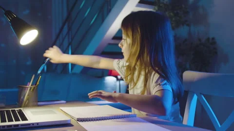 Homework With Laptop Computer.Focused Preschool child Studying at Table doing Stock Footage 240454763
