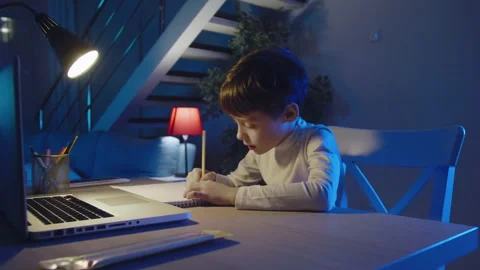 Homework With Laptop Computer.Focused Schoolchild Studying at Table doing Video stock 176919169
