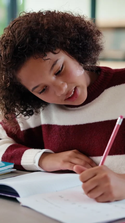 Homework, thinking and child writing with math answer for activity sheet Stockbeeldmateriaal 335848183