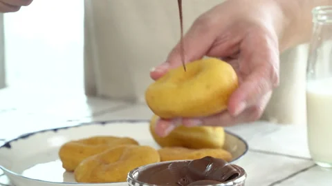 Hommade donut spreading hazelnut chocolate spread on it Stock Footage 205217257