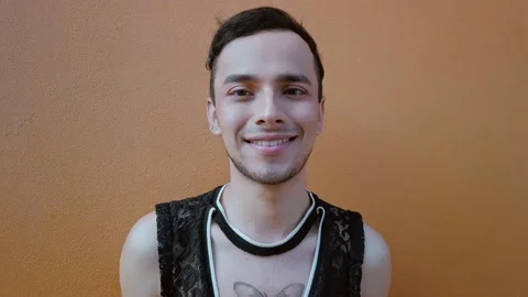 Homosexual man looking at camera while smiling uneasily. Stock Footage 192079521