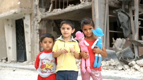 Homs, Syria, September 2013. Children play among the destroyed house in a Stock Footage