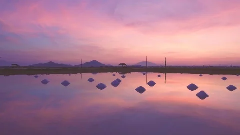 Hon Khoi salt fields ready for salt harvest at sunrise, Vietnam Stock Footage 99212544