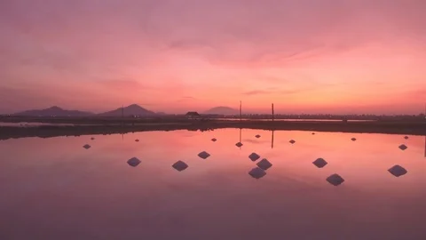Hon Khoi salt fields ready for salt harvest at sunrise, Vietnam Stock Footage 99212550