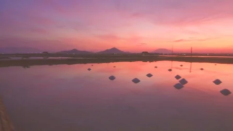 Hon Khoi salt fields ready for salt harvest at sunrise, Vietnam Stock Footage 99212588