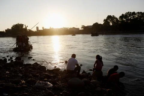 Hondurans wait at the border between Mexico and Guatemala for additional members Stock Photos