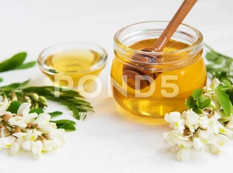 Honey with acacia blossoms Stock Photos