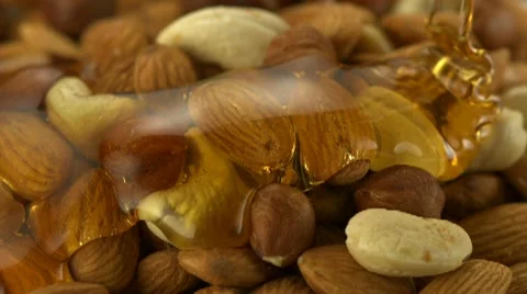 Honey on almond and nuts, Slow Motion Stock Footage