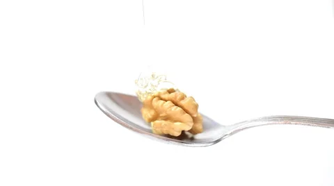 Honey and walnuts on spoon close up Stock Footage 35713499