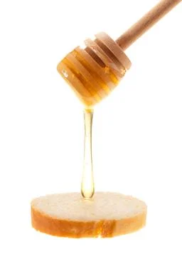 Honey is applied to the surface of bread. Isolated on a white background. Foto stock