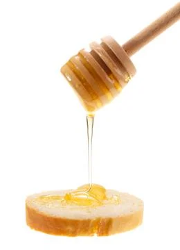 Honey is applied to the surface of bread. Isolated on a white background. Stock-Fotos