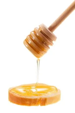 Honey is applied to the surface of bread. Isolated on a white background. Stock Photos