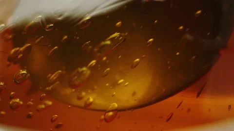 Honey with bubbles in disfocus Stock Footage 161077229