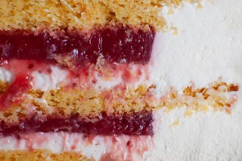 Honey cake layers with raspberry jam and white curd cream texture close up. H Stock Photos