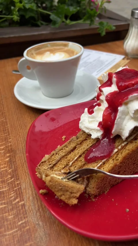Honey cake on plate being broken with fork in street cafe in summer. Vertical Stock Footage 246498716
