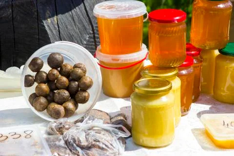 Honey in cans and propolis Stock Photos