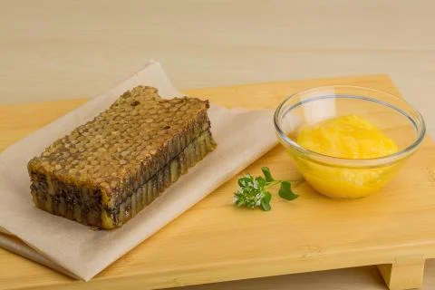 Honey with comb Stock Photos