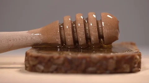 Honey Dipper with Honey on a Slice of Bread Stock Footage 110848130